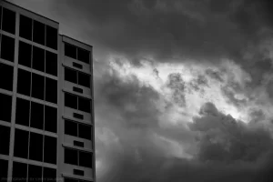 Forboding skies over an abandoned high rise building.