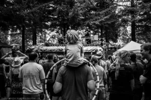 Father and son watching The Giraffe Dodgers play atop Ken Kesey's Mystery Bus at Northwest String Summit.