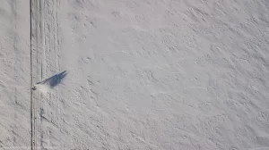 A man snowblows a long driveway after a winter storm in central North Dakota.
